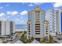Exterior view of a blue and yellow oceanfront building, showcasing the beachside location at 2501 South Ocean Blvd. # 1011, Myrtle Beach, SC 29577