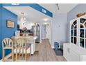 Bright kitchen with white cabinets, stainless steel appliances, and a view into the living space at 2501 South Ocean Blvd. # 1011, Myrtle Beach, SC 29577