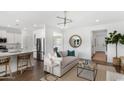 Open concept living room with modern decor, hardwood floors, lots of natural light, and seamless kitchen access at 3326 Wood Stork Dr., Ocean Isle Beach, NC 28469