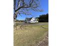 Charming two-story home with black shutters, landscaping and mature trees at 3534 Carter Rd., Loris, SC 29569