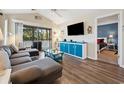Comfortable living room with a large screen television and view to screened porch at 366 Pinehurst Ln. # 13E, Pawleys Island, SC 29585