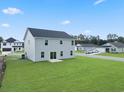View of a large backyard with green grass, and other modern homes in the background at 44 Cape Point Dr., Conway, SC 29527