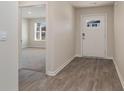 Inviting foyer with wood-look flooring leading to a bright living space and the front door at 4480 East Coast Ln., Shallotte, NC 28470