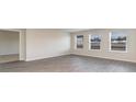 Bright living room with three windows and modern wood-look flooring creating a cozy atmosphere at 4480 East Coast Ln., Shallotte, NC 28470