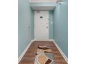 Entryway and hall to the home is decorated with soft blue walls and wood floors at 501 S Ocean Blvd. # 1006, North Myrtle Beach, SC 29582
