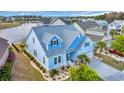 Aerial view of this well maintained two-story home, with a manicured lawn and landscaping near the pond at 6004 Flowerdale Ct., Myrtle Beach, SC 29579