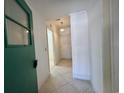Hallway showcases tiled flooring, beadboard paneling, with neutral paint creating a bright and inviting space at 61 Lakewood Dr., Andrews, SC 29510