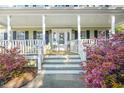 Inviting covered porch with detailed trim and beautiful plants at the entrance to the home at 837 Flicker Pl., Murrells Inlet, SC 29576