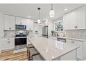 Bright kitchen featuring white cabinets, granite countertops, a kitchen island, and stainless steel appliances at 837 Flicker Pl., Murrells Inlet, SC 29576