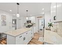 Bright kitchen featuring white cabinets, granite countertops, a kitchen island, and stainless steel appliances at 837 Flicker Pl., Murrells Inlet, SC 29576