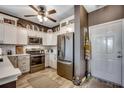 Modern kitchen with stainless steel appliances, white cabinets, and a decorative backsplash at 901 West Port Dr. # 2101, North Myrtle Beach, SC 29582