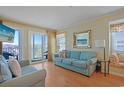Bright living room with comfortable seating, stylish decor, and balcony access at 9580 Shore Dr. # 311, Myrtle Beach, SC 29572
