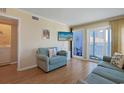 Inviting living area with cozy furnishings, TV, and access to a private balcony at 9580 Shore Dr. # 311, Myrtle Beach, SC 29572