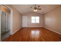 Bright living room with hardwood floors, a ceiling fan and a large window at 9972 Conifer Ln., Murrells Inlet, SC 29576