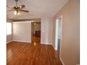 Open living room boasts hardwood floors, neutral walls, and a ceiling fan at 9972 Conifer Ln., Murrells Inlet, SC 29576