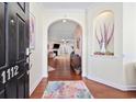 Inviting foyer with hardwood floors, arched doorway, and decorative niche creates a warm welcome at 1112 Raven Cliff Ct., Conway, SC 29526