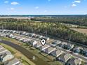 Wide aerial shot showcases the home's location, backing onto the picturesque pond, offering serene views and neighborhood charm at 2888 Pegasus Place, Myrtle Beach, SC 29577