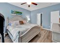 Comfortable bedroom featuring stylish nautical decor, wood flooring, and abundant natural light at 329 Lake Mist Ct., Longs, SC 29568