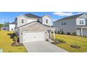 Two-story home featuring a stone facade and attached two-car garage, complemented by a well-manicured lawn at 4032 Bayhill St., Myrtle Beach, SC 29579