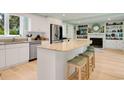 Bright kitchen features a large kitchen island with seating, stainless steel appliances, and granite countertops at 52 Trimmings Ct., Pawleys Island, SC 29585