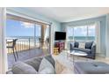 Bright living room with a sliding glass door opening to a balcony overlooking the ocean at 707 S Ocean Blvd. # 602, North Myrtle Beach, SC 29582