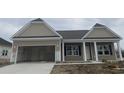New single-story home featuring a two-car garage, covered entry and simple landscaping at 997 Oak Hollow St., Longs, SC 29568