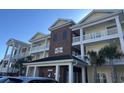 Three story building with balconies and yellow siding and brick accents at 1025 Ray Costin Way # 1008, Murrells Inlet, SC 29576