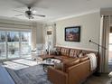 Bright living room with a leather sectional sofa, and a view to an outdoor patio at 1025 Ray Costin Way # 1008, Murrells Inlet, SC 29576