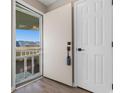 Condo entryway with an open door and wood-look flooring at 1101 Possum Trot Rd. # C-303, North Myrtle Beach, SC 29582