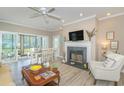 Cozy living room with fireplace, ceiling fan, and access to a screened porch at 110-4 White Tail Way # 4, Pawleys Island, SC 29585