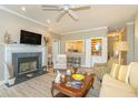 Warm living room with fireplace, built-in bar area, and view into the kitchen at 110-4 White Tail Way # 4, Pawleys Island, SC 29585
