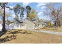 Lovely exterior view of a single story home with a large yard and a white picket fence at 150 Brookgate Dr., Myrtle Beach, SC 29579