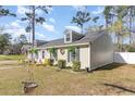 Landscaped yard with mature trees surrounds this single story home with quaint dormer windows at 150 Brookgate Dr., Myrtle Beach, SC 29579