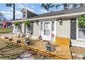 Welcoming front porch with rocking chairs and potted plants offers a charming curb appeal at 150 Brookgate Dr., Myrtle Beach, SC 29579