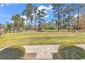 Enjoy views from this condo of meticulously manicured common green space with mature pines and a white picket fence at 1505 Lanterns Rest Rd. # 101, Myrtle Beach, SC 29579