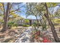 Inviting condo entrance framed by mature trees and manicured landscaping at 178 Salt Marsh Circle # 30D, Pawleys Island, SC 29585
