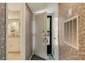 Entryway featuring wallpaper, a view into the kitchen, and closet doors at 25 Gate 1 # 25, Carolina Shores, NC 28467