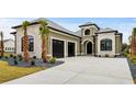 Stunning home boasts a two-car garage, stone accents, and immaculate landscaping around the property at 311 73Rd Ave. N, Myrtle Beach, SC 29572