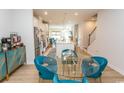 Bright dining area featuring stylish teal chairs, a glass table, and an open view of the kitchen and living area at 341 Golan Circle # B, Myrtle Beach, SC 29579