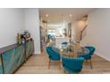 Bright dining area featuring stylish teal chairs, a glass table, and an open view of the kitchen and living area at 341 Golan Circle # B, Myrtle Beach, SC 29579