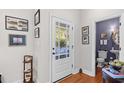 Bright foyer with hardwood floors, decorative accents, and a view into a powder room at 381 Da Gullah Way # 8 B, Pawleys Island, SC 29585