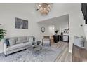 Bright living room with vaulted ceilings, light wood flooring, plush sofa, and an open kitchen at 400 Cambridge Circle # L-7, Murrells Inlet, SC 29576