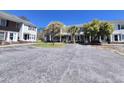 Wide view of condos with parking lot and grassy areas surrounding the buildings at 4115 Little River Rd. # 10-B, Myrtle Beach, SC 29577