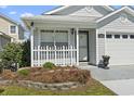Close up of the front entry featuring a white picket fence and a lovely gray brick driveway at 413 Chesterfield Ct., Myrtle Beach, SC 29577