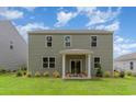 Relaxing backyard featuring a covered patio and a well-maintained lawn, perfect for outdoor entertaining at 414 Acosta Circle, Conway, SC 29527