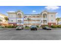 Condo complex featuring covered balconies and well-manicured landscaping and parking at 4141 Hibiscus Dr. # 201, Little River, SC 29566