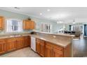 Open kitchen featuring wooden cabinets, stainless sink, and view to the living room at 4141 Hibiscus Dr. # 201, Little River, SC 29566
