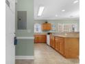 View of kitchen with wooden cabinets, tile floors, and countertops at 4141 Hibiscus Dr. # 201, Little River, SC 29566