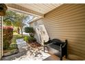 Cozy front porch with bench seating, complemented by lush greenery and a glimpse of the home's exterior at 4195 Wrens Crossing, Little River, SC 29566
