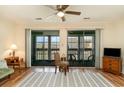 Bright living room features sliding glass doors, ceiling fan, and wood-look flooring with a patterned rug at 500 Fairway Village Dr. # 5D, Myrtle Beach, SC 29588